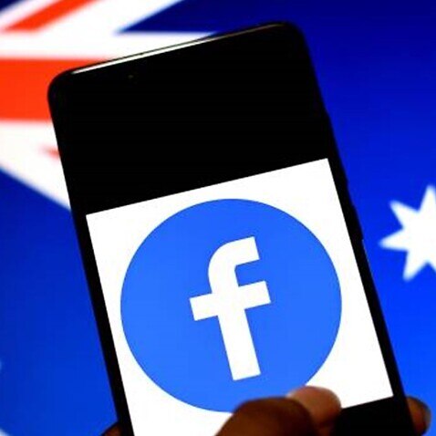 The Facebook logo seen displayed on a Smartphone with an Australian flag in the background. 