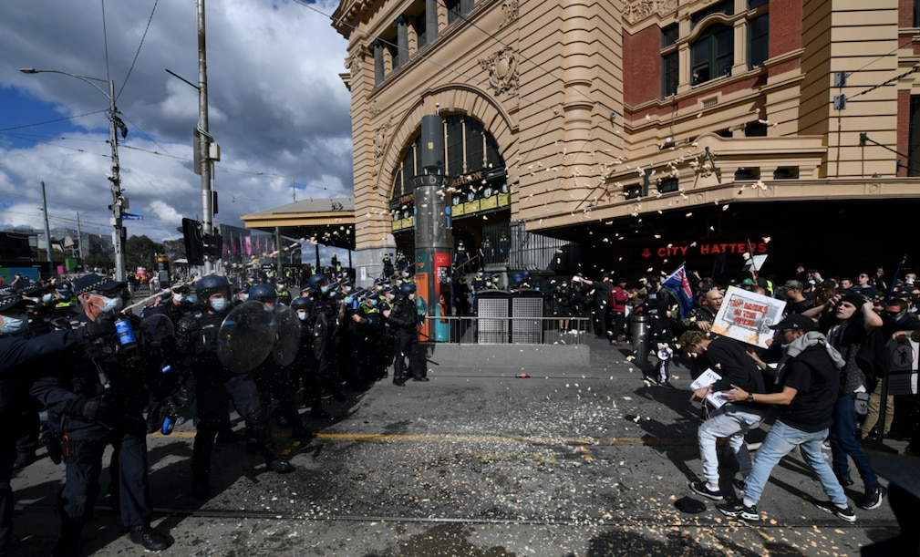 Protesters are pepper sprayed by police during an anti-lockdown protest in Melbourne on 21 August 2021.
