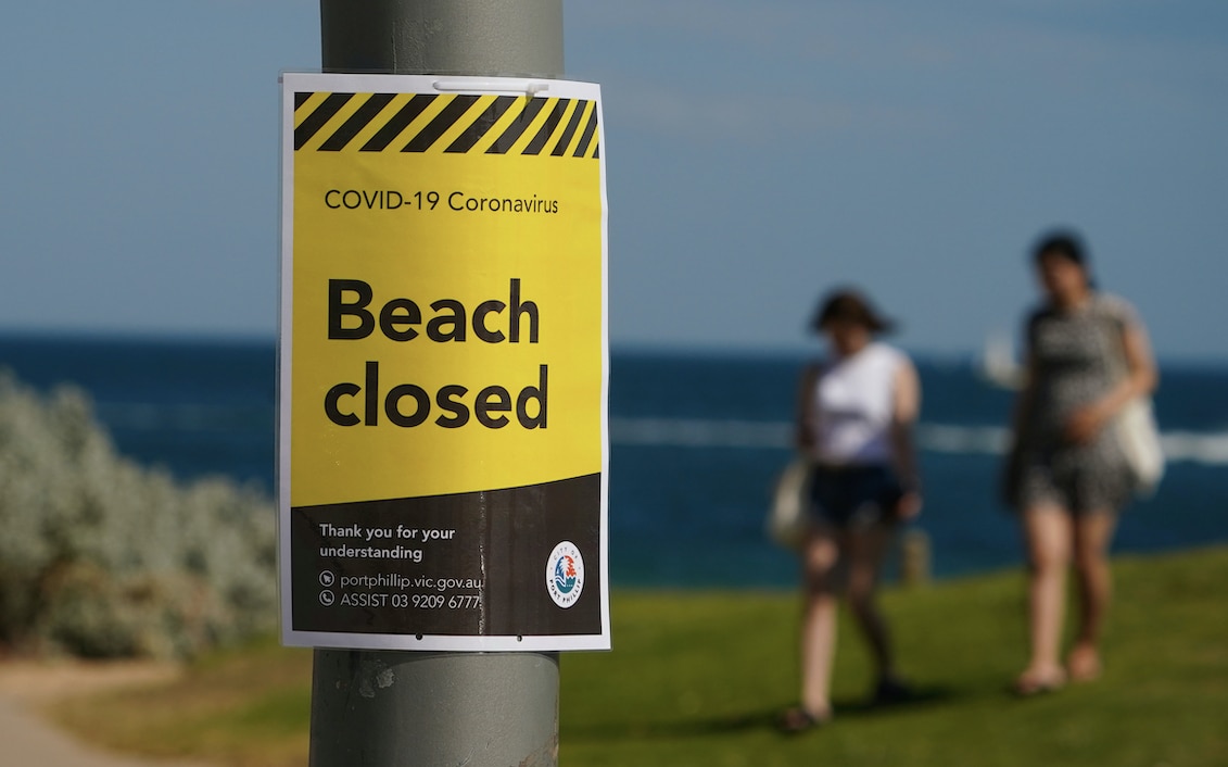 A "beach closed" sign is seen at St Kilda Beach in Melbourne.