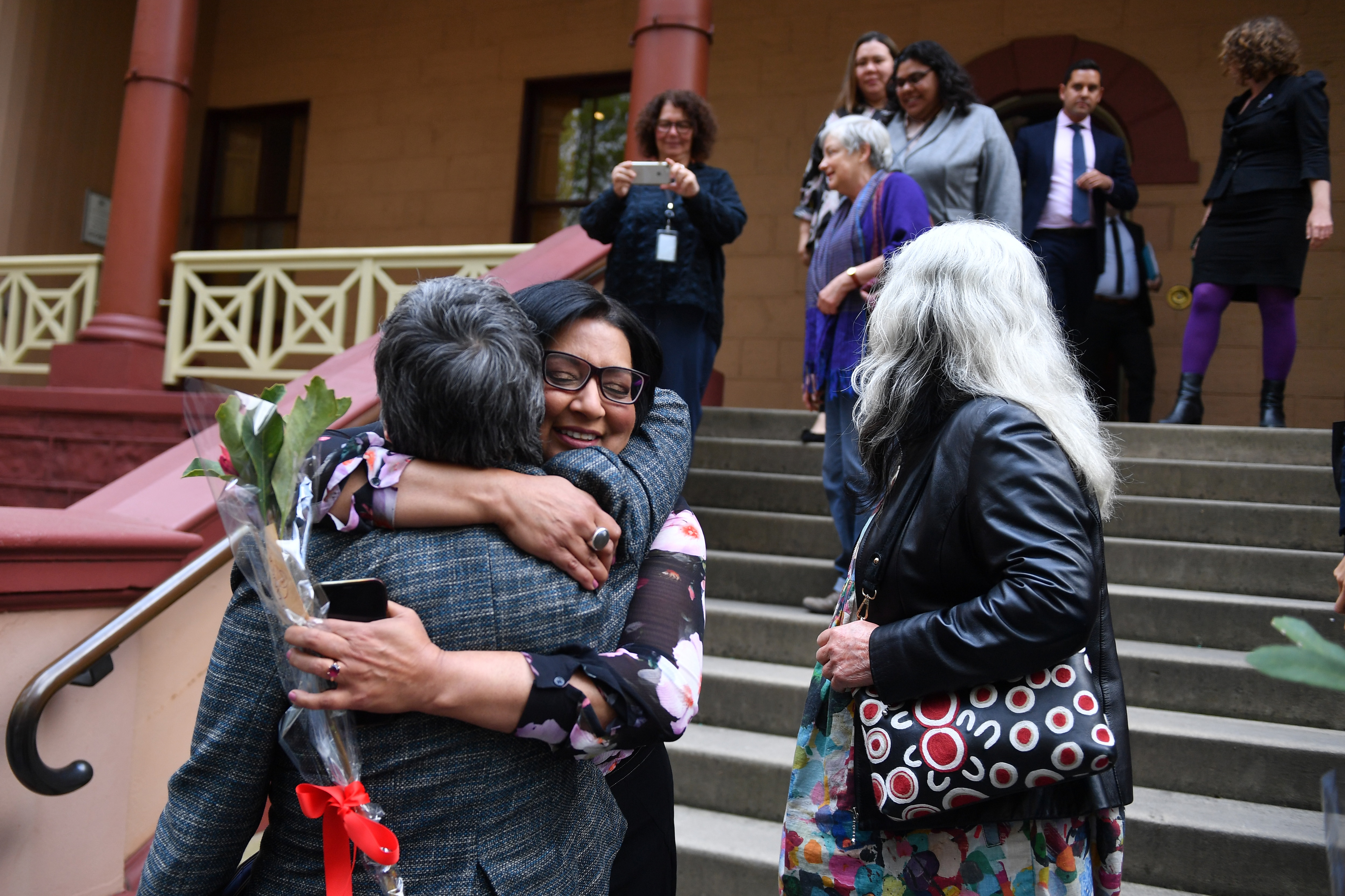 Greens MP's Jenny Leong and Mehreen Faruqi - both long-time abortion rights campaigners - embrace outside NSW Parliament.