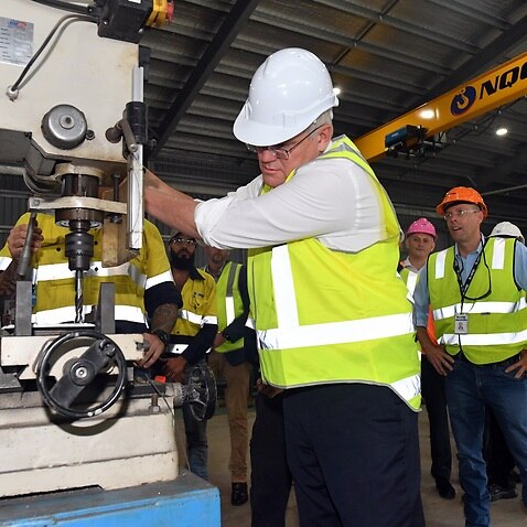 Prime Minister Scott Morrison drills a hole at Norship shipyard engineering facility on Day 18 of the 2022 federal election campaign, in Cairns, in the seat of Leichhardt. Thursday, April 28, 2022. (AAP Image/Mick Tsikas) NO ARCHIVING
