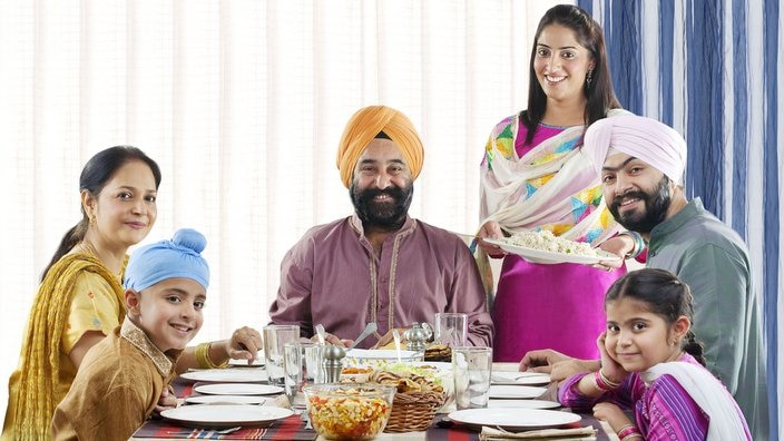 Sikh family having lunch at the table, Punjabi Parents