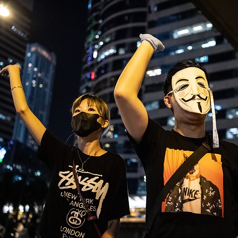 People protest a government ban on face masks in Hong Kong.