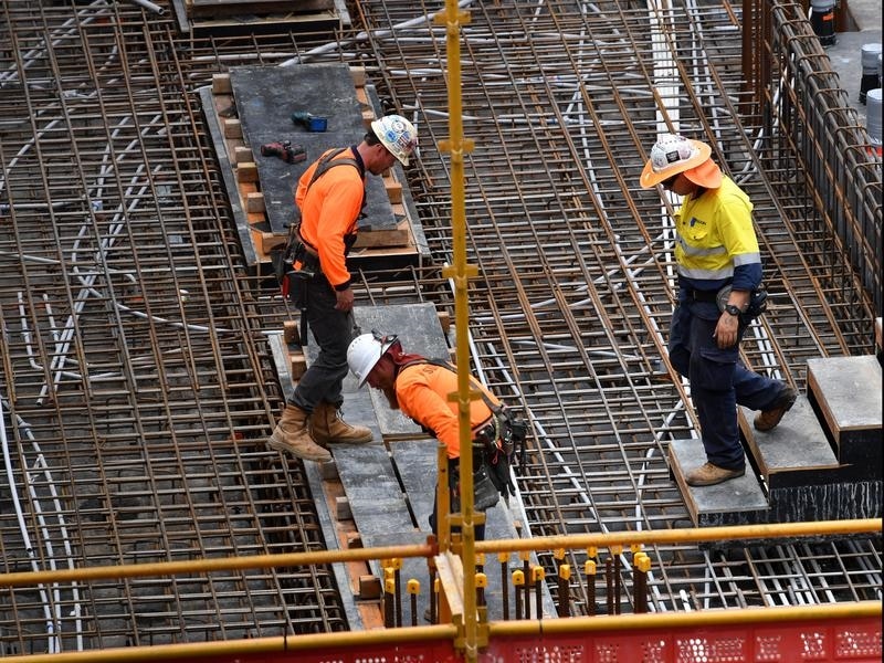 Construction workers are seen on a building site.