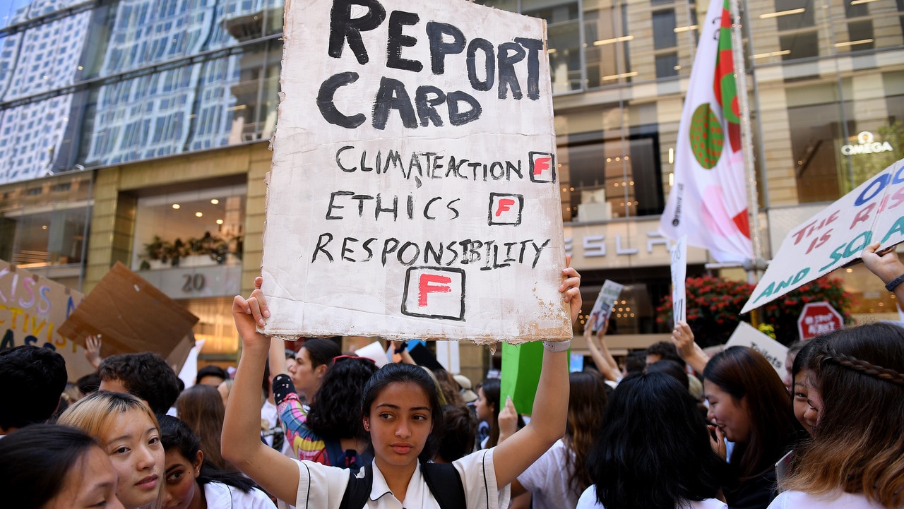 Kayna Fichadia of North Sydney Girls' High School holds a placard during the protest.