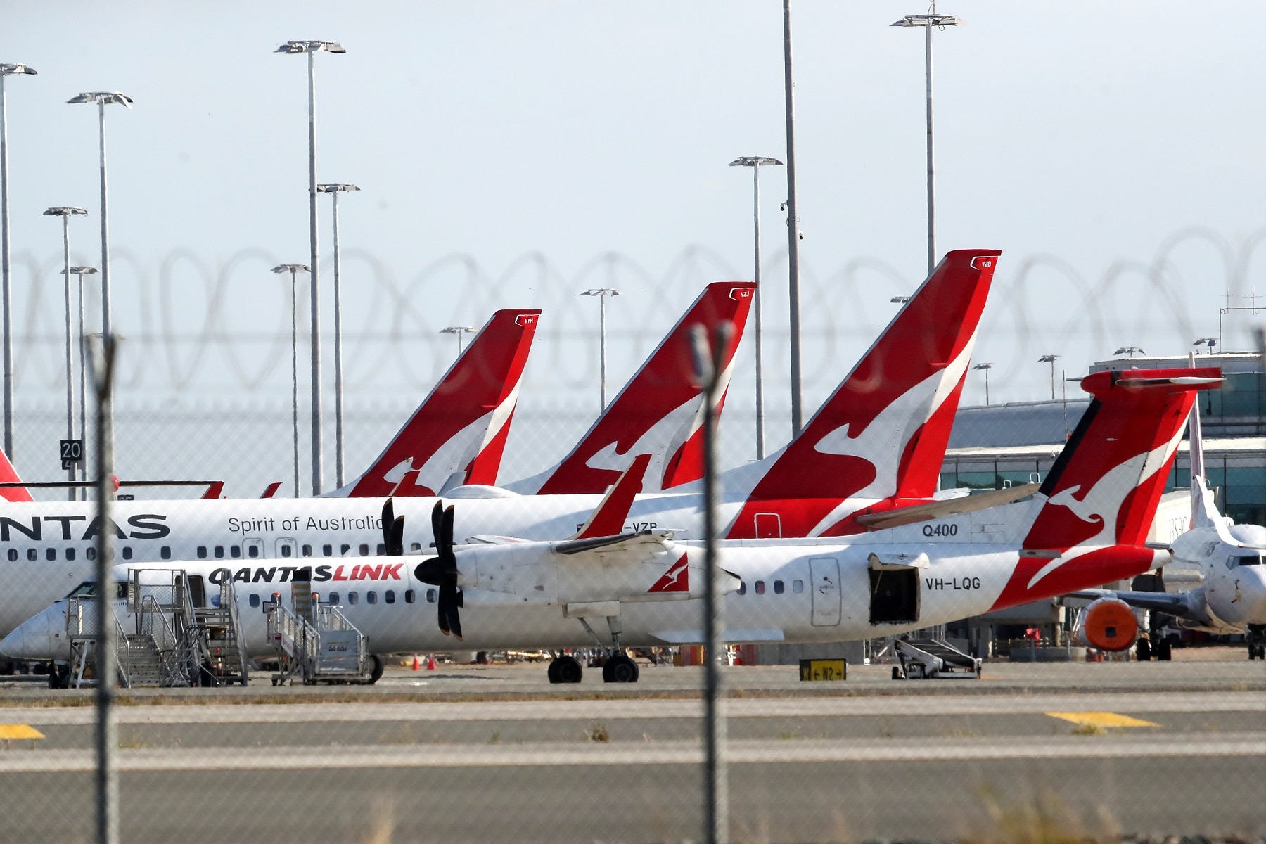 A general view of Qantas planes at Brisbane domestic airport. Monday, September 20, 2021. A traveller has tested positive for COVID-19 after potentially being infectious at Brisbane Airport for four hours.(AAP Image/Jono Searle) NO ARCHIVING