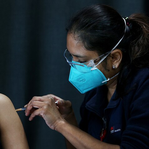 Registered Nurse Shalini administers a Pfizer COVID-19 vaccine to a person visiting the Australian Sikh Association (ASA) pop-up clinic in Sydney.