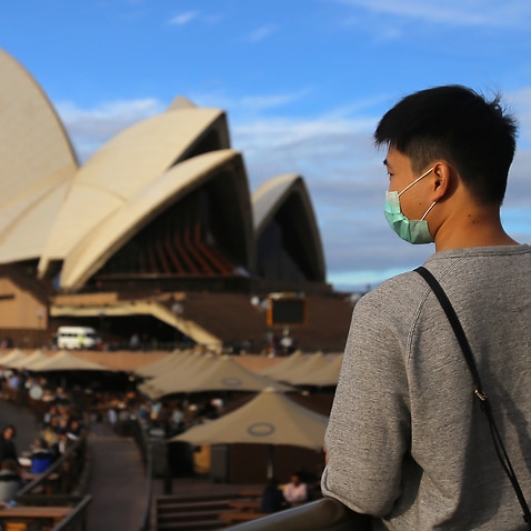 People wear face masks at the Sydney Opera House in Sydney.