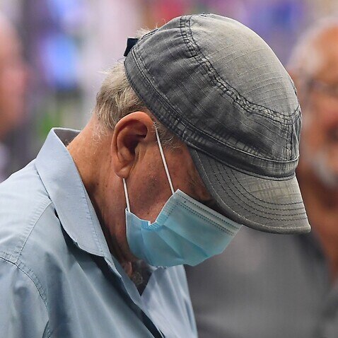 A man wears a face mask as a preventative measure against corona virus in Coburg, Melbourne,     