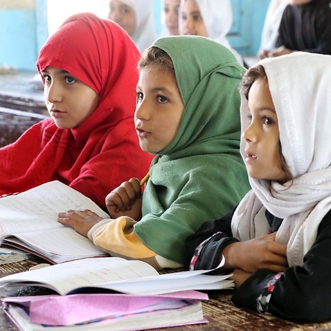 Afghan school girls attend their school in Kandahar, Afghanistan, 18 October 2021.