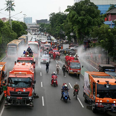 A number of major roads on bus routes in Jakarta are sprayed