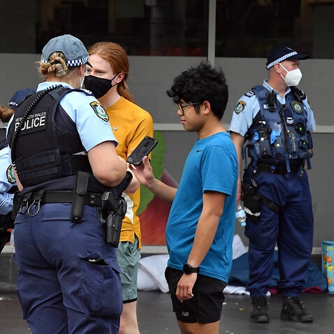 NSW police check identifications at George St in front of the Sydney Town Hall in anticipation of an anti-lockdown rally in Sydney Sydney, Saturday, July 31, 2021. (AAP Image/Mick Tsikas) NO ARCHIVING