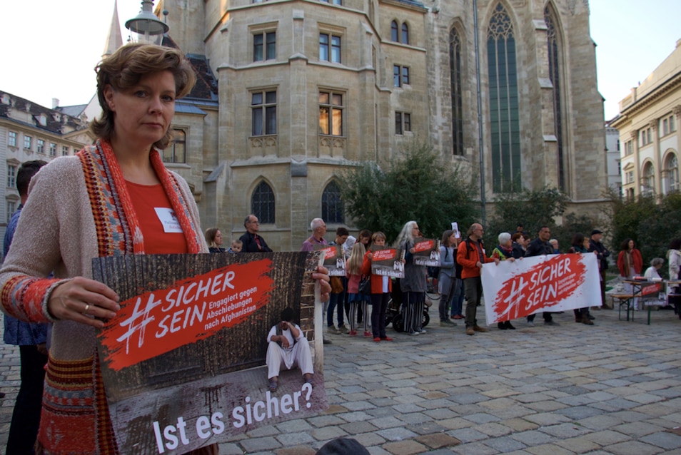 Erika Kudweis holds a sign saying 'Be safe. Is it safe?' at a demonstration in Vienna. 