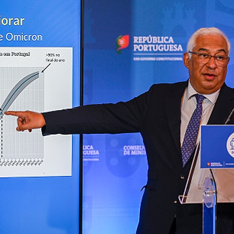 Portuguese Prime Minister Antonio Costa pointing to a chart showing the worsening COVID-19 situation in Portugal due to Omicron.