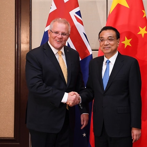 Australian Prime Minister Scott Morrison (left) shakes hands with the Premier of the People's Republic of China Li Keqiang (centre right) during a bilateral meeting