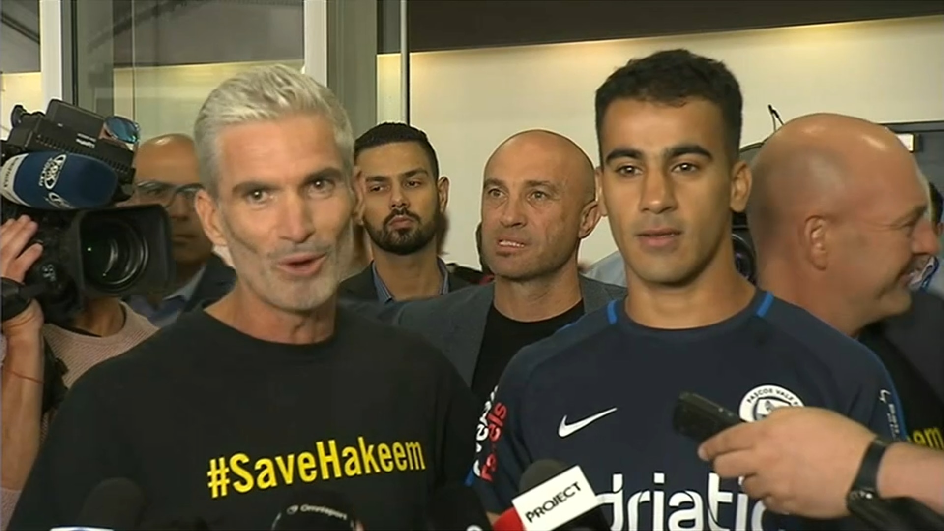Craig Foster and Hakeem Al-Araibi speak to reporters after the footballer's return to Melbourne.