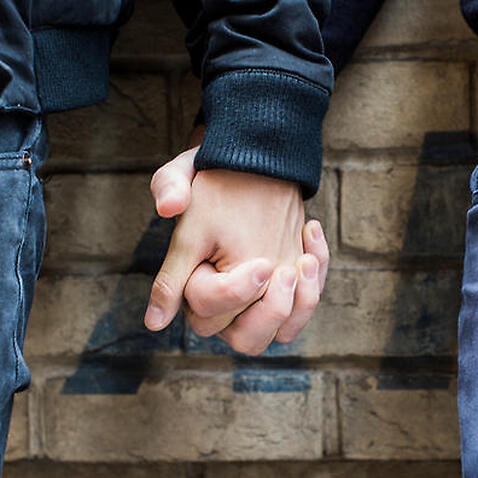 Close Up of Gay Couple Holding Hands