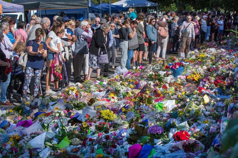 Members of the public look at a makeshift memorial along Rolleston Avenue in Christchurch on Tuesday.