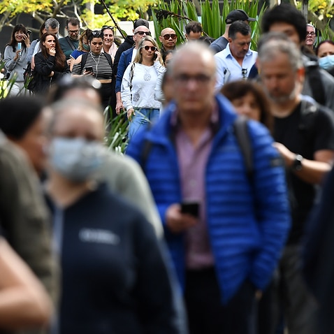 Members of the public wait for a vaccine at a mass COVID-19 vaccination hub in Sydney, Monday, May 24, 2021. (AAP Image/Joel Carrett) NO ARCHIVING