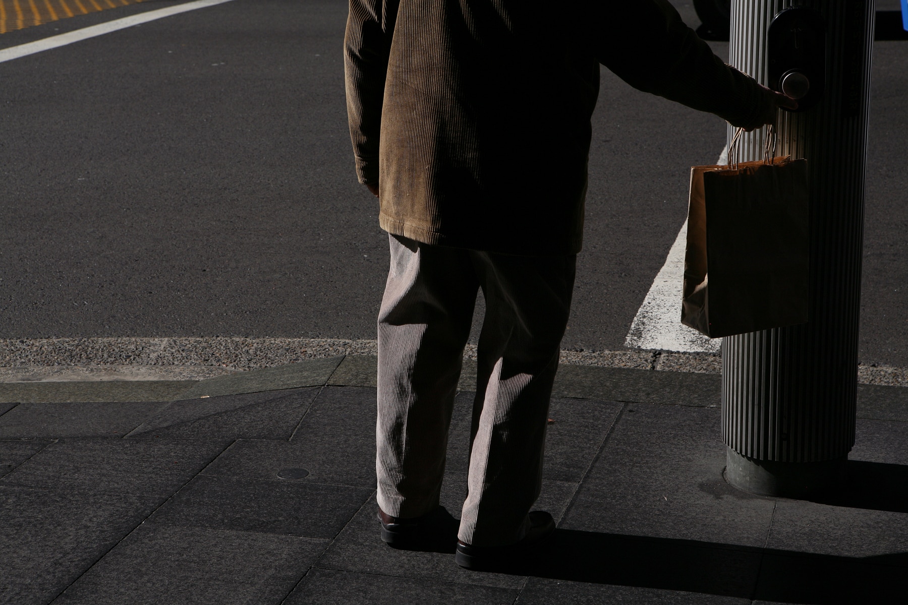 An elderly man waits at traffic lights on George Street in Sydney, Wednesday, May 18, 2011. (AAP Image/Angela Brkic) NO ARCHIVING