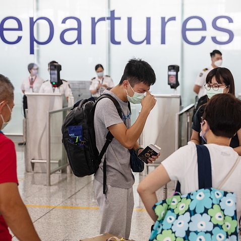  A young man cries as he says goodbye to relatives in the departure hall before boarding a London-bound flight in Hong Kong International Airport in Hong Kong, China, 08 August 2021 (issued 09 August 2021). Thousands of Hong Kong residents are taking up t
