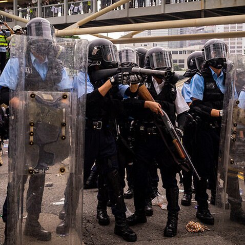 Hong Kong riot police prepare to deploy tear gas against protesters (AAP)