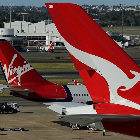 A Qantas (R) and a Virgin (L) plane sit