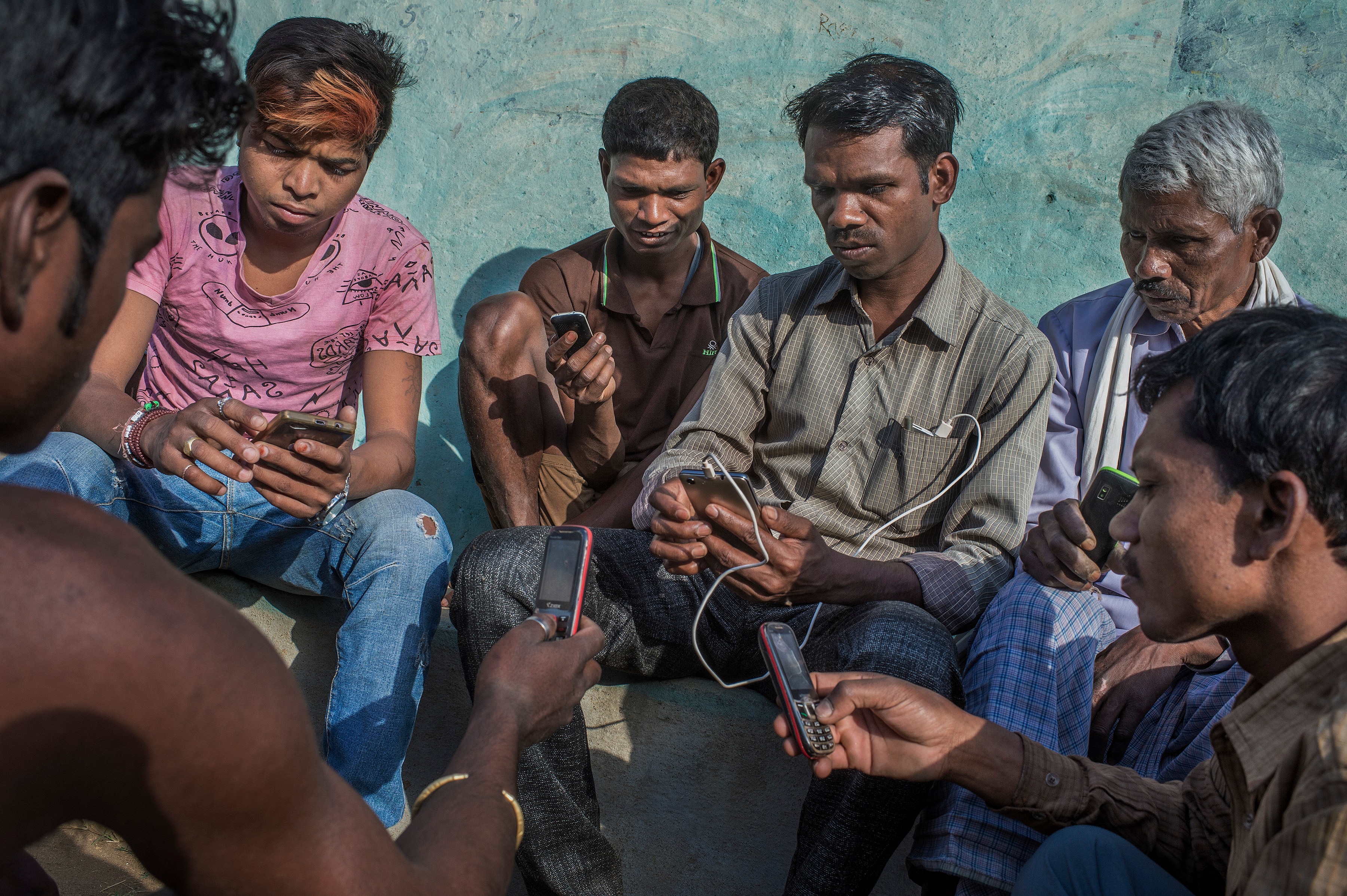 Babulal Singh Neti, center, teaches villagers how to use mobile phones in Taradand, India. Babulal Singh Neti, center, teaches villagers how to use mobile phones in Taradand, India.