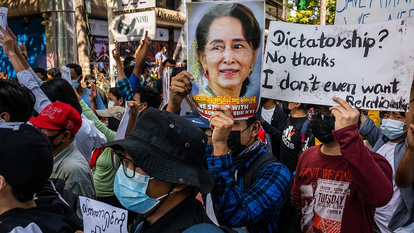 Protesters hold images of de-facto leader Aung San Suu Kyi on 10 February, 2021 in Yangon, Myanmar.