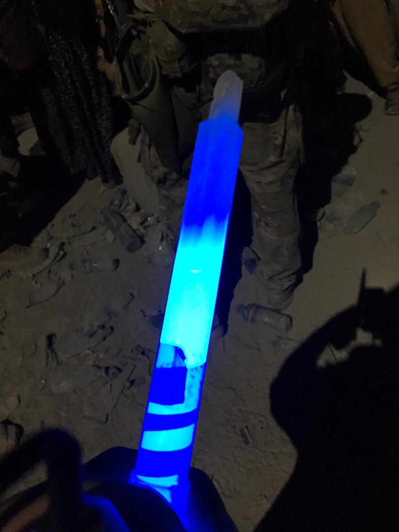 The glow stick shone by an interpreter to his mates waiting in line at Kabul airport