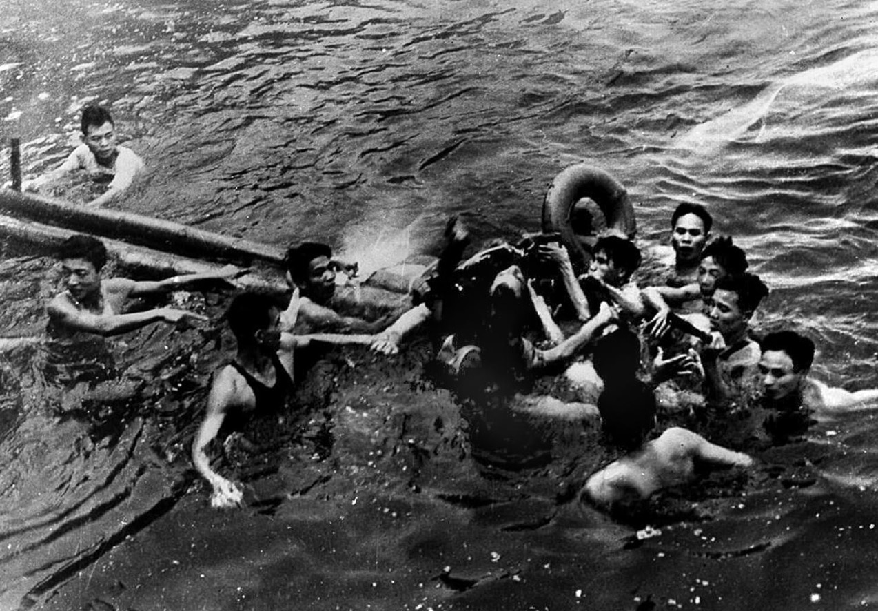 A photo taken 26 October 1967 shows US Navy Airforce Major John McCain (C) being rescued from Hanoi's Truc Bach lake by several Hanoi residents