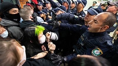 Police clashing with protesters inside Central Station.