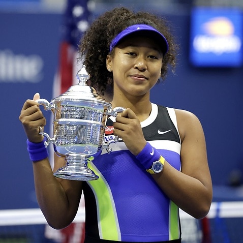 Naomi Osaka of Japan celebrates with the Championship Trophy after defeating Victoria Azarenka to win the Women's Final at the US Open.