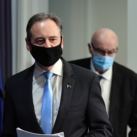 Minister for Health Greg Hunt and Therapeutic Goods Administration (TGA) Deputy Secretary Professor John Skerritt arrive at a press conference at Parliament House in Canberra, Wednesday, October 27, 2021. (AAP Image/Mick Tsikas) NO ARCHIVING