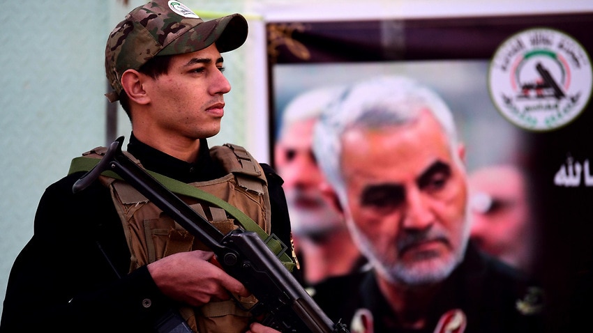 A member of an Iran-backed Iraqi Shiite armed group stands in front of a military base in Baghdad, 7 January 2020.