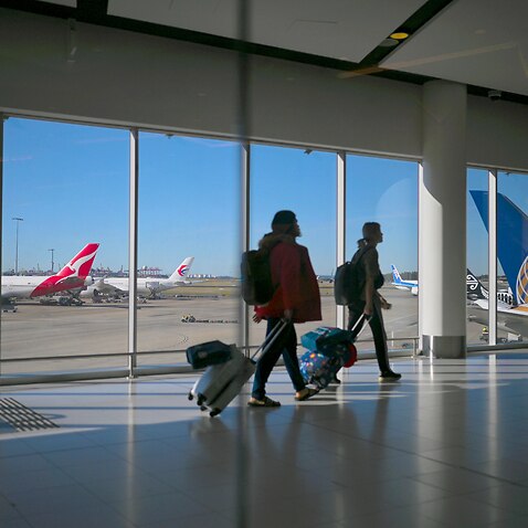 Passengers walk to their flights at Sydney International Airport 