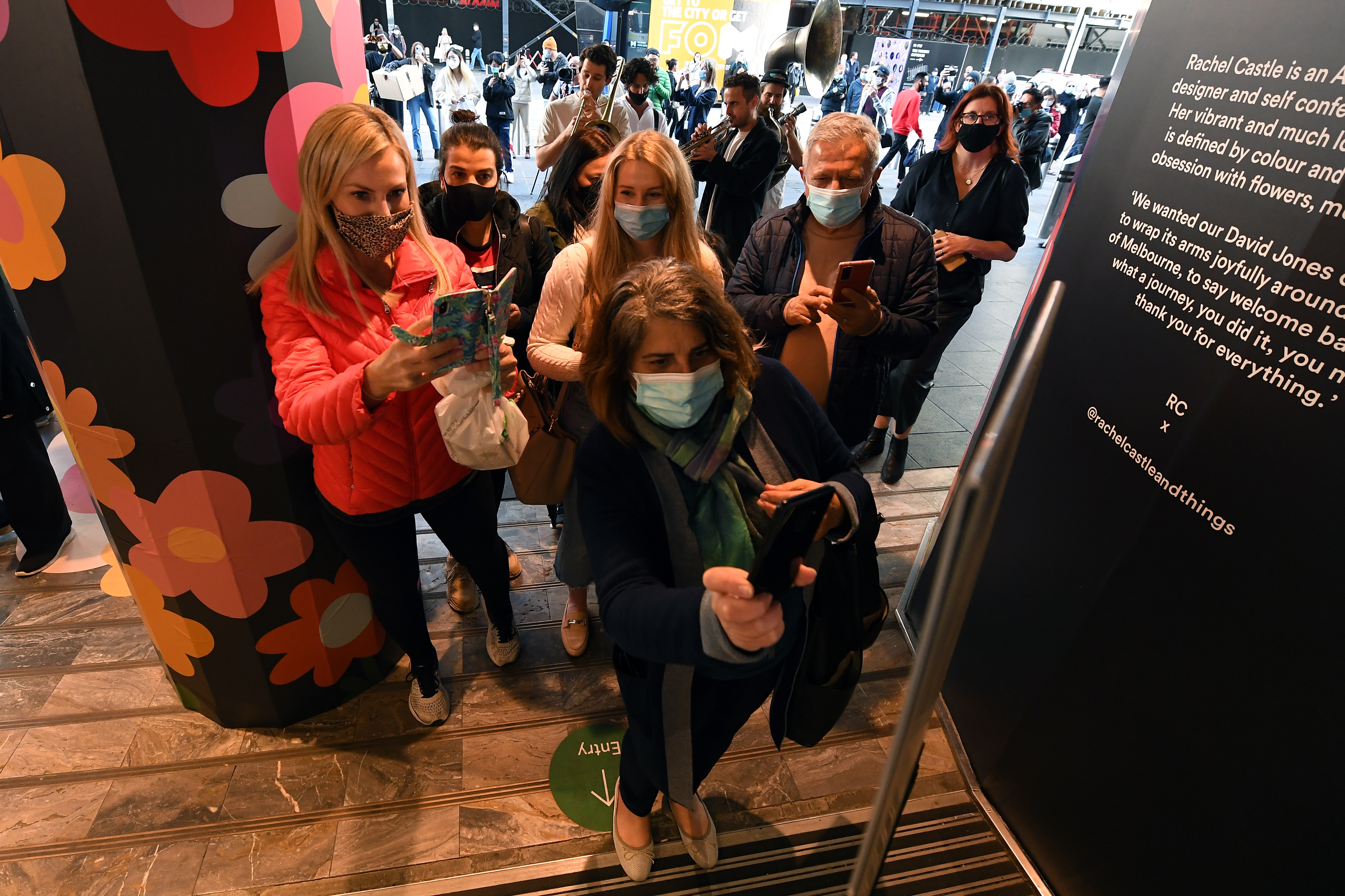 People use a QR code before entering the David Jones retail store in Melbourne, Friday, October 29, 2021. At 6pm, the border between Melbourne and the regions will come down, masks will no longer need to be worn outdoors, indoor entertainment venues, gyms