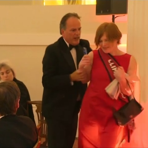 Activist Janet Barker being grabbed by MP Mark Field