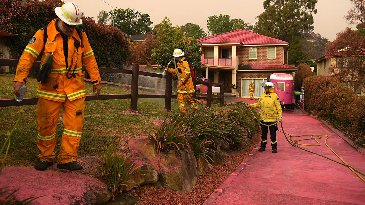 Chemical fire retardant covers the houses on Canoon Rd and Barwon Avenue South Turramurra as firefighters prepare. 