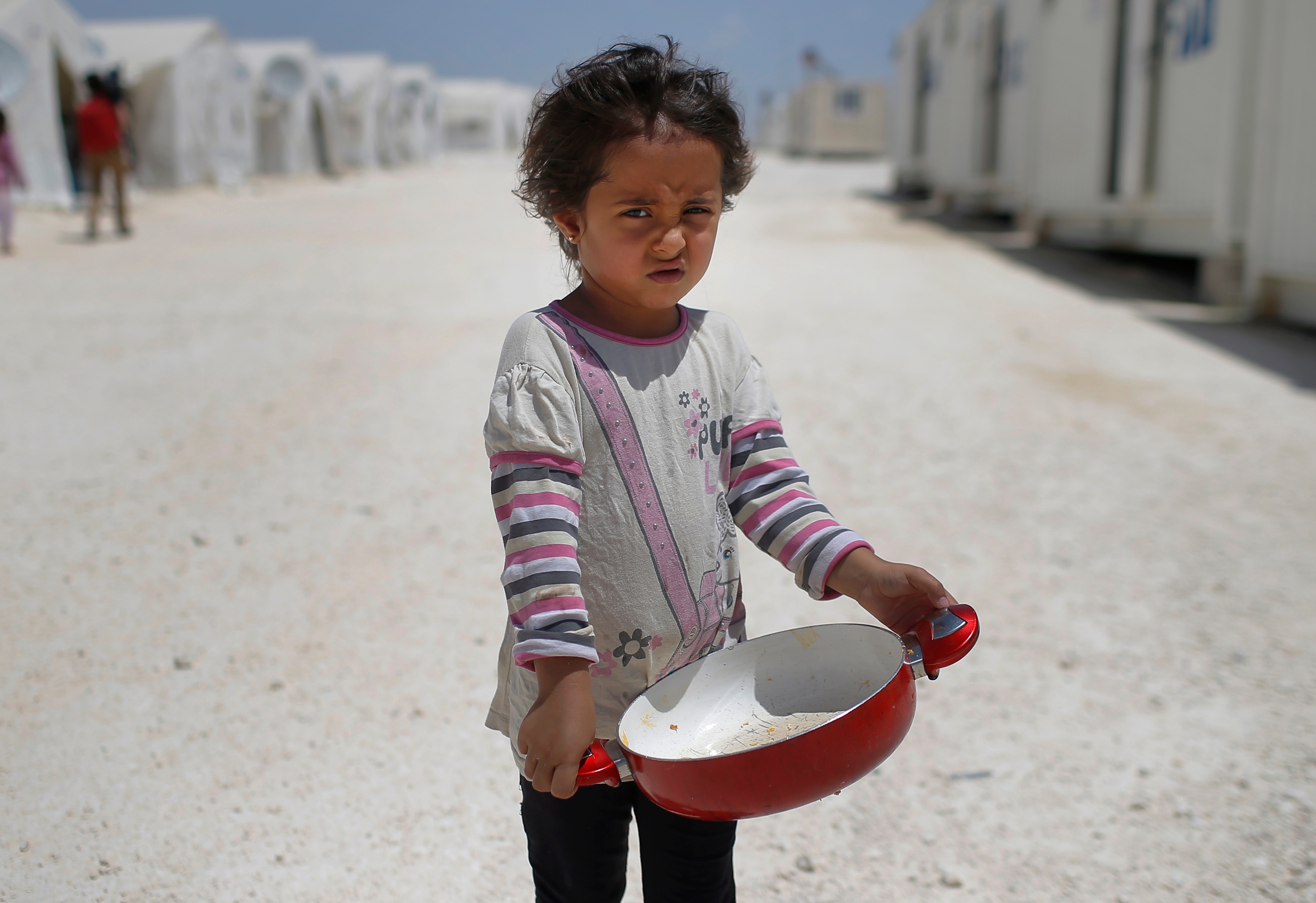 Syrian refugee child walks at a refugee camp in Suruc, on the Turkey-Syria border. Syrian refugee child walks at a refugee camp in Suruc, on the Turkey-Syria border. 28 million children around the globe are refugees (AP Photo/Emrah Gurel).