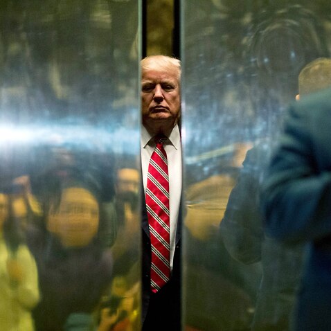 US President-elect Donald Trump boards the elevator in Trump Tower in New York City, Jan 16, 2017.
