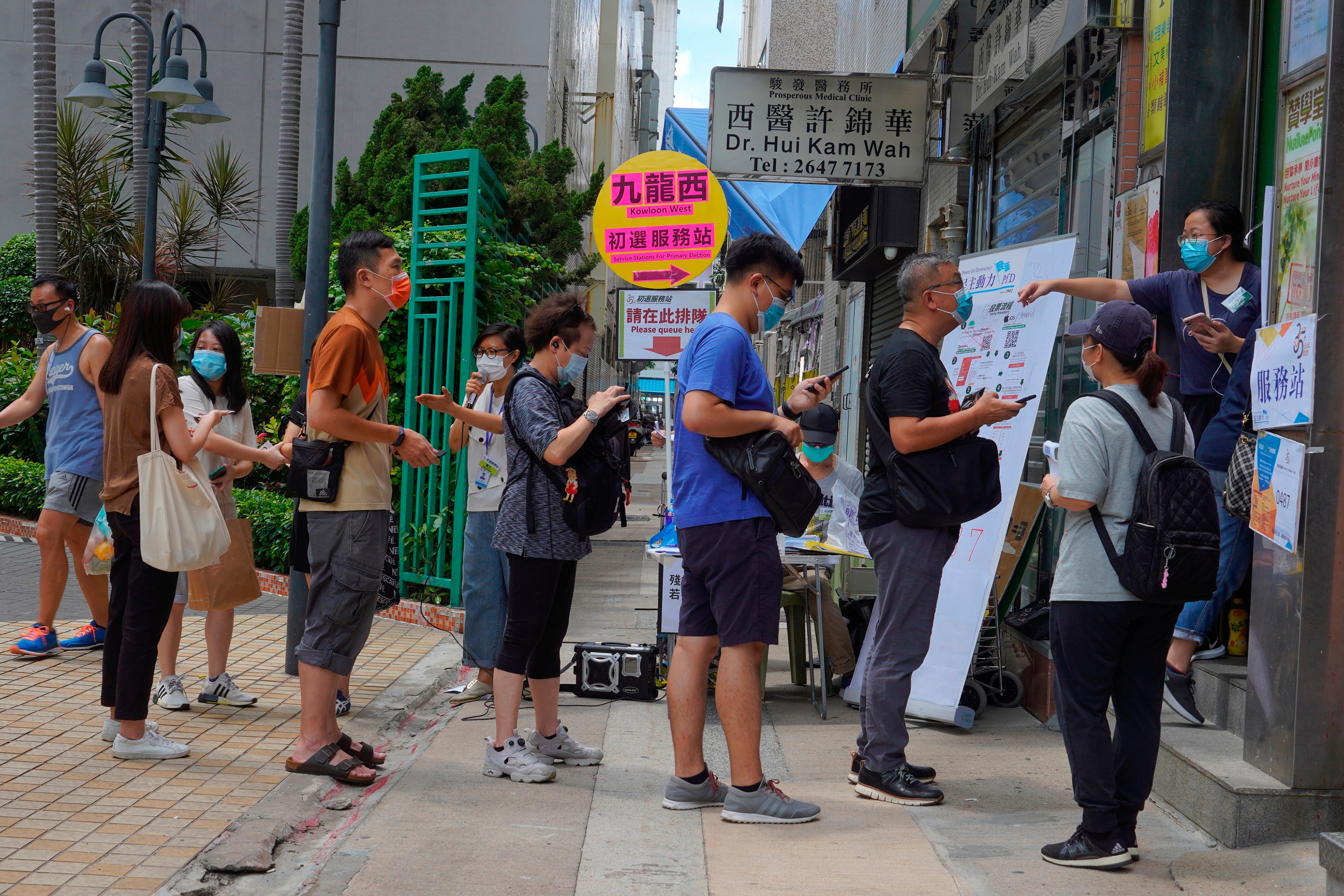People queue up to vote in Hong Kong in an unofficial primary for pro-democracy candidates ahead of legislative elections in September. People queue up to vote in Hong Kong in an unofficial primary for pro-democracy candidates ahead of legislative elections in September.