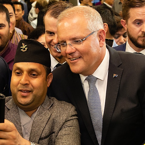 Australian Prime Minister Scott Morrison has a selfie taken with Nepali community members during a visit to the Koondoola Community Centre in Perth SBS