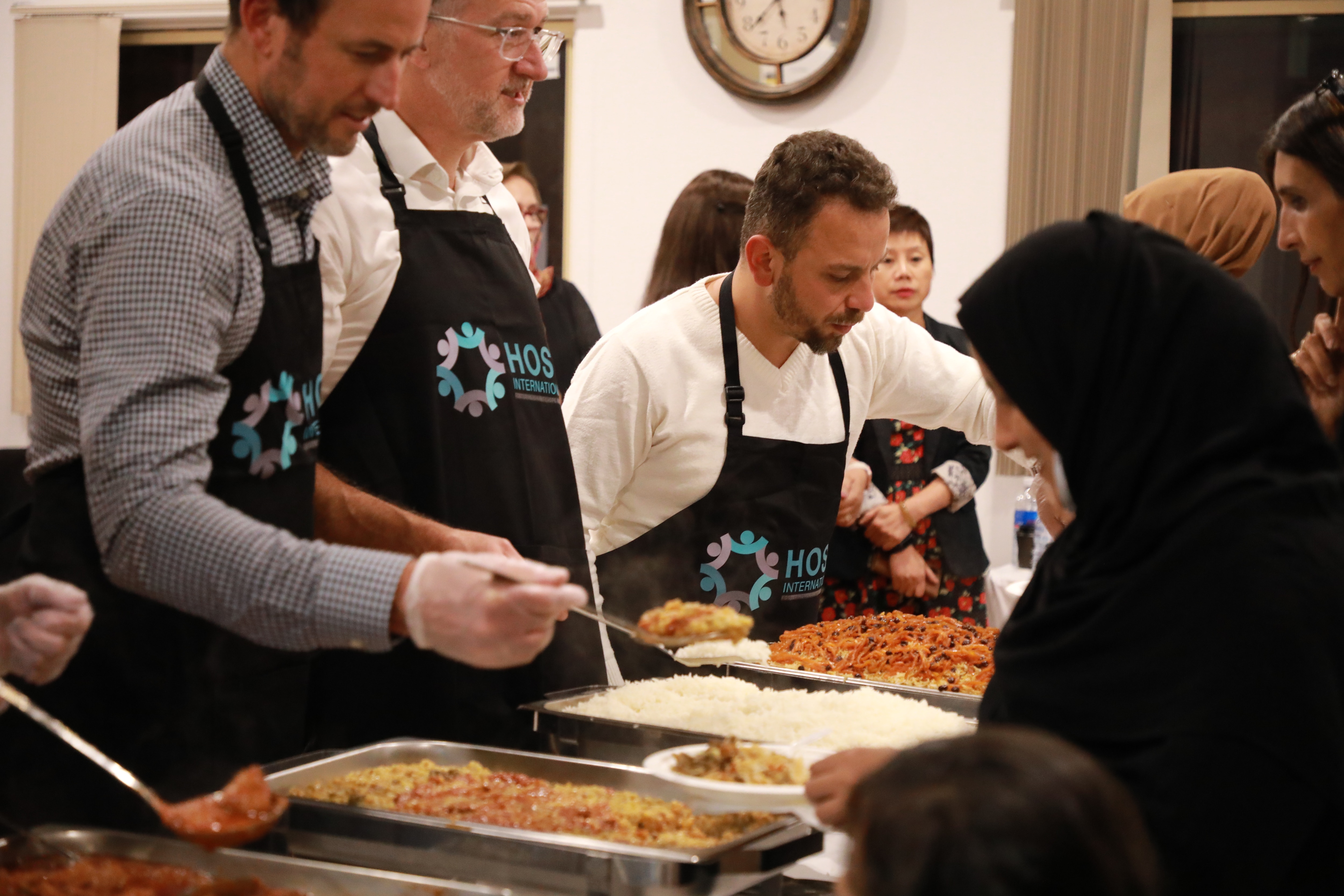 HOST International volunteers serve up the Iftar meal.