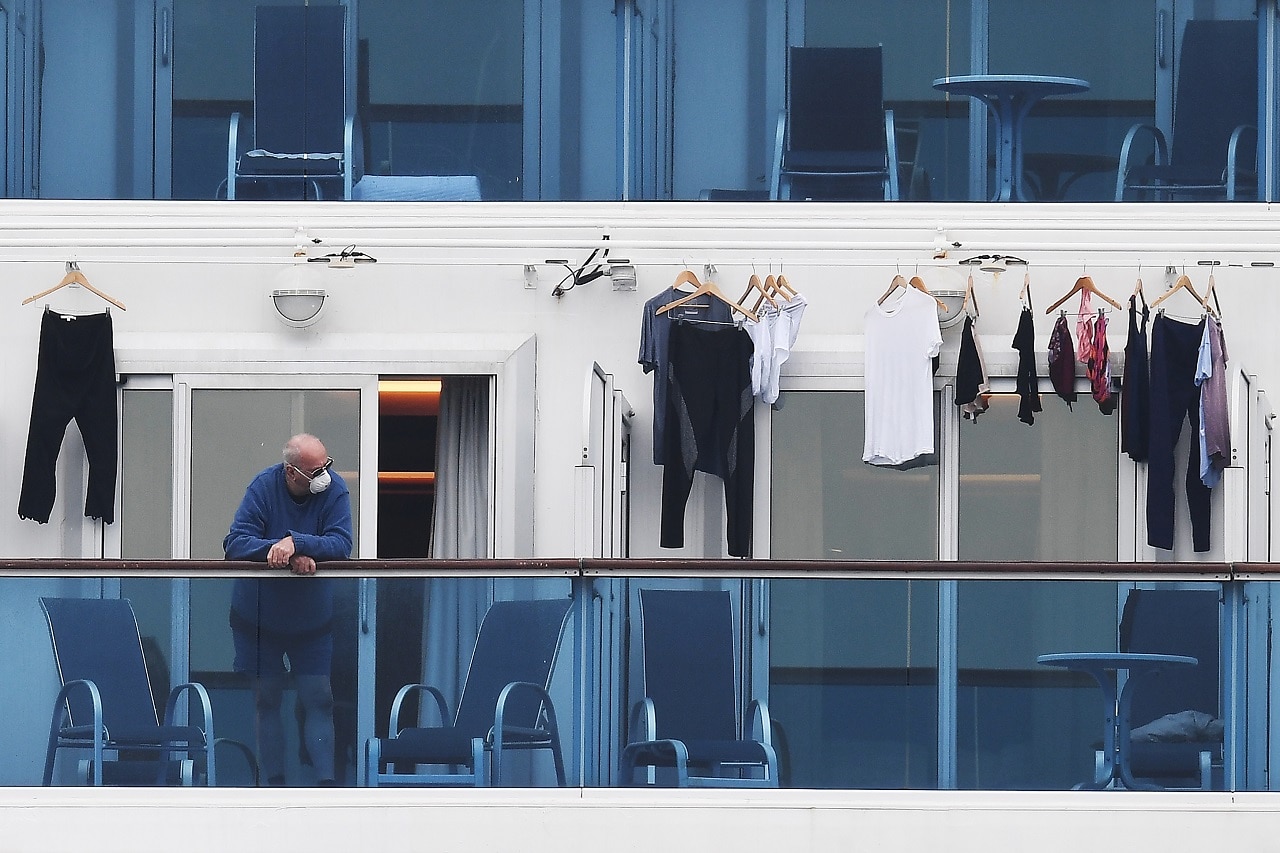 A passengers is seen on a balcony of the Diamond Princess cruise ship.