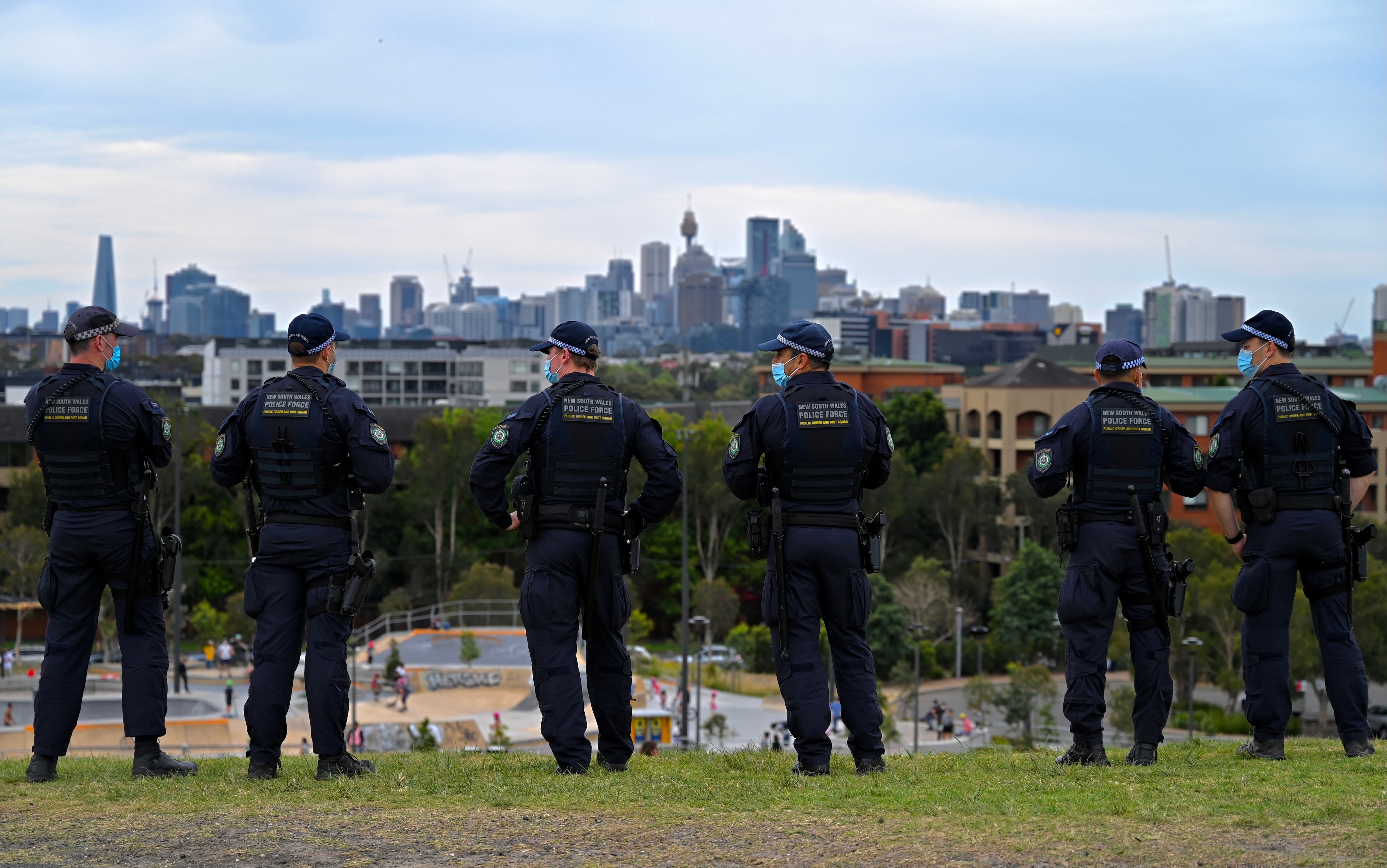 The Sydney CBD is seen at police officers patrol Sydney Park in order to prevent an anti-lockdown protest.