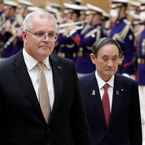 Australian Prime Minister Scott Morrison and Japan's Prime Minister Yoshihide Suga observe an honor guard  in Tokyo, Japan, 17 November 2020. 