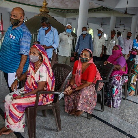 People line up to register for a COVID-19 vaccination at a mosque in Ahmedabad, India