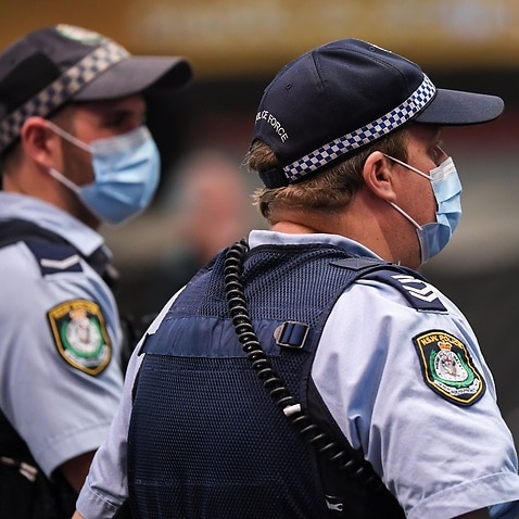 Police officers wear face masks in Sydney.