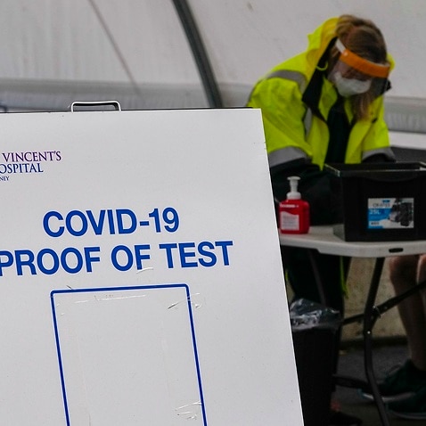 A woman waits to receive a COVID-19 test in the eastern suburbs of Sydney Tuesday, Sept. 14, 2021. 